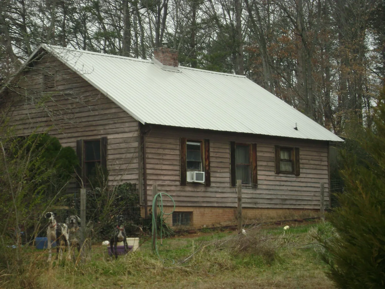 White metal roof on an old wood sided farmhouse, from a Metal Roof Installation job in West Islip